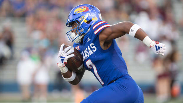 Kansas redshirt junior wide reciever Trevor Wilson (7) takes off after a punt return in the first quarter of Friday's game against Missouri State inside David Booth Kansas Memorial Stadium.  